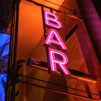 Colourful neon signboard bar lightning and flashing at night city
